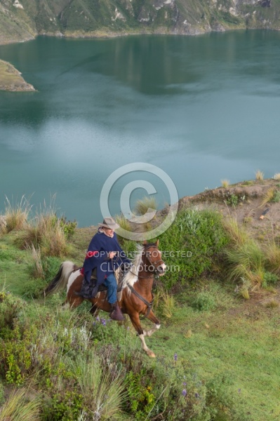 Gabriel riding at  Crater Lake at Quilotoa volcano