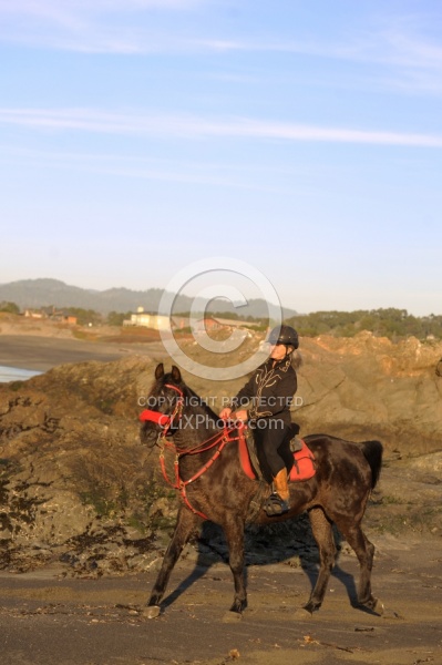 Lari Shea of Ricochet Ridge Ranch riding on the beach